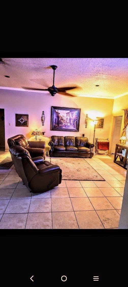 2293 Heatherdale Dr, Mesquite, TX 75150 - tiled living room featuring a textured ceiling
