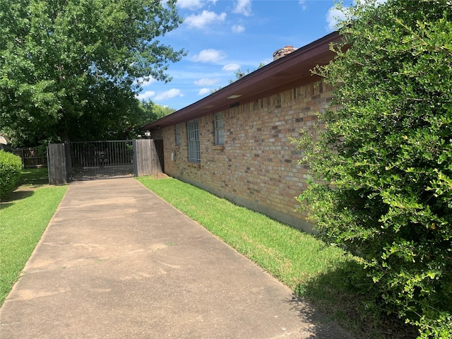 1726 Crescent Dr, Sherman, TX 75092 - view of property exterior with brick siding and a gate