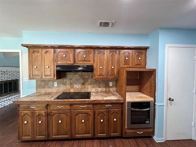 1726 Crescent Dr, Sherman, TX 75092 - kitchen with stainless steel oven, extractor fan, black electric cooktop, and backsplash