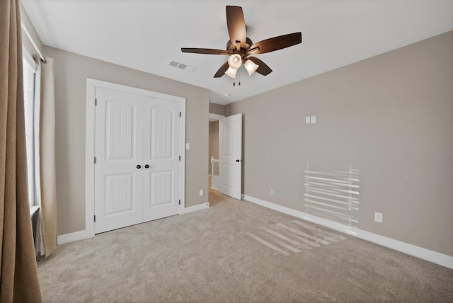 940 E 5th St, Springtown, TX 76082 - unfurnished bedroom featuring a closet, light carpet, and a ceiling fan