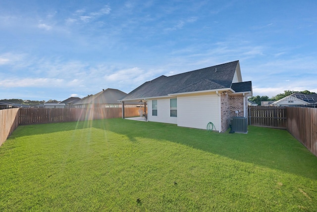 940 E 5th St, Springtown, TX 76082 - rear view of property featuring a fenced backyard, a shingled roof, and brick siding