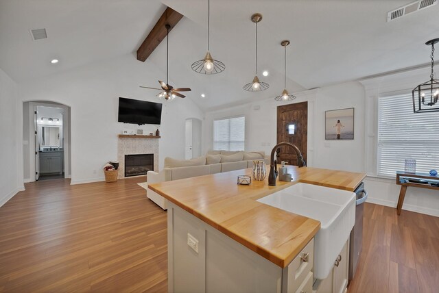 940 E 5th St, Springtown, TX 76082 - kitchen featuring wood counters, arched walkways, ceiling fan, and recessed lighting