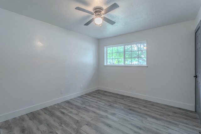 10029 Grove Oaks Blvd, Dallas, TX 75217 - unfurnished room with wood finished floors, ceiling fan, and a textured ceiling