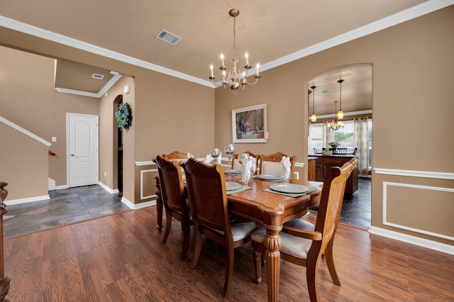 701 Champlain Ct, Midlothian, TX 76065 - dining space with a chandelier, dark wood finished floors, arched walkways, and ornamental molding