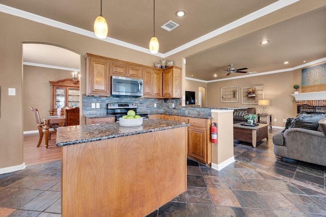 701 Champlain Ct, Midlothian, TX 76065 - kitchen featuring appliances with stainless steel finishes, stone tile floors, open floor plan, arched walkways, and a ceiling fan