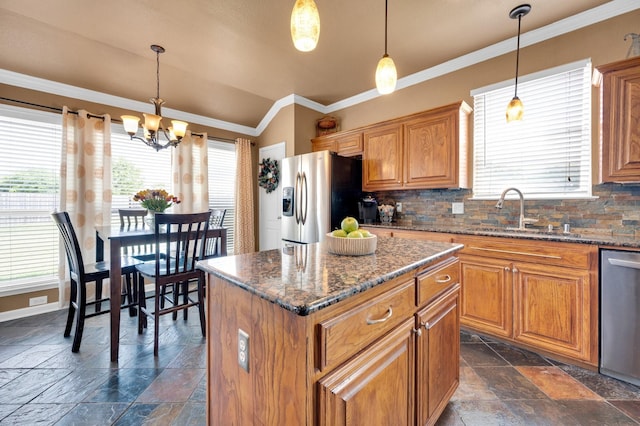 701 Champlain Ct, Midlothian, TX 76065 - kitchen with stainless steel appliances, stone tile floors, healthy amount of natural light, brown cabinetry, and crown molding