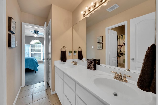 701 Champlain Ct, Midlothian, TX 76065 - bathroom with connected bathroom, double vanity, a ceiling fan, and tile patterned floors