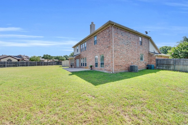 701 Champlain Ct, Midlothian, TX 76065 - rear view of house with brick siding, a chimney, a patio area, and a fenced backyard