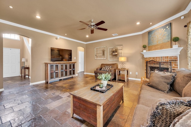 701 Champlain Ct, Midlothian, TX 76065 - living room with arched walkways, crown molding, recessed lighting, ceiling fan, and stone tile flooring