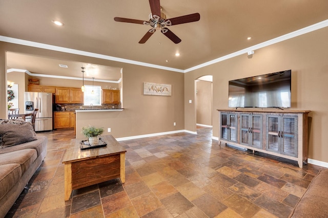701 Champlain Ct, Midlothian, TX 76065 - living room featuring ceiling fan, arched walkways, stone tile flooring, recessed lighting, and ornamental molding