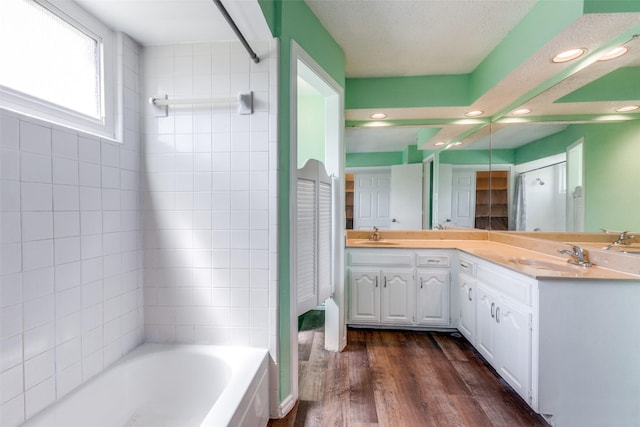 1308 Choctaw Dr, Mesquite, TX 75149 - full bath featuring a bath, double vanity, wood finished floors, a shower, and recessed lighting