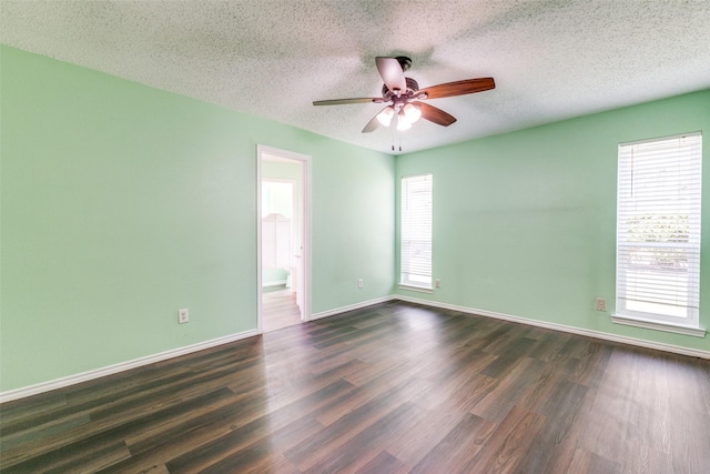 1308 Choctaw Dr, Mesquite, TX 75149 - unfurnished room with healthy amount of natural light, dark wood-type flooring, a textured ceiling, and a ceiling fan