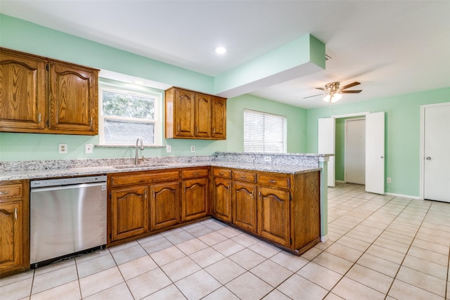 1308 Choctaw Dr, Mesquite, TX 75149 - kitchen with stainless steel dishwasher, a peninsula, brown cabinetry, healthy amount of natural light, and recessed lighting