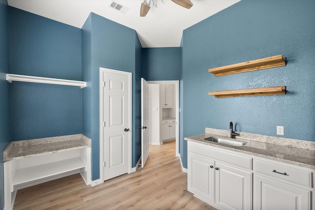 6417 Gehrig Cir, Burleson, TX 76028 - washroom featuring light wood-type flooring, a ceiling fan, and a textured wall