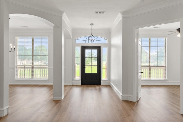 6417 Gehrig Cir, Burleson, TX 76028 - entryway with arched walkways, crown molding, light wood finished floors, ceiling fan, and a chandelier