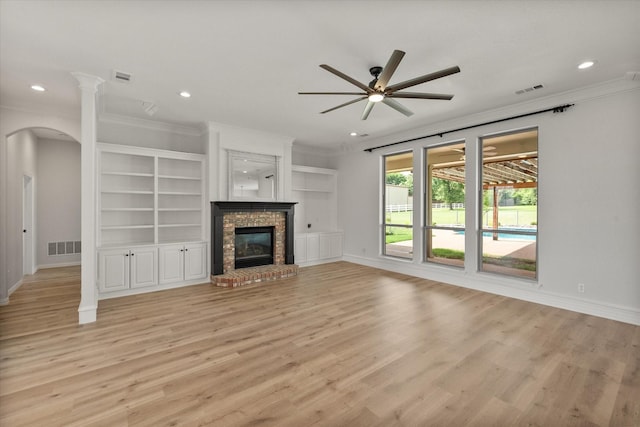 6417 Gehrig Cir, Burleson, TX 76028 - unfurnished living room featuring crown molding, a ceiling fan, recessed lighting, light wood-style flooring, and arched walkways