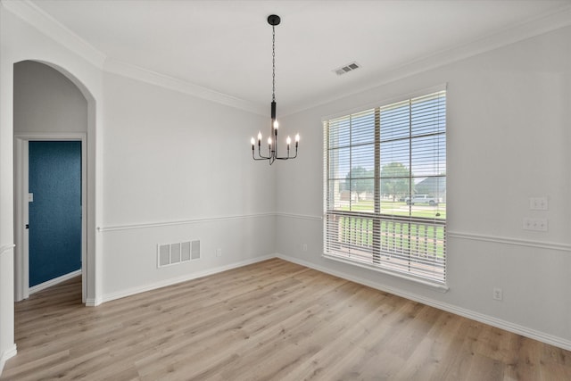 6417 Gehrig Cir, Burleson, TX 76028 - spare room featuring a chandelier, crown molding, light wood finished floors, and arched walkways