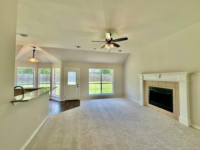 917 Calder St, Howe, TX 75459 - unfurnished living room with carpet flooring, ceiling fan, a tile fireplace, and vaulted ceiling