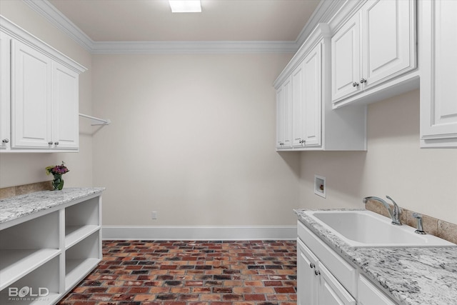 1030 Winterberry Ln, Shreveport, LA 71106 - laundry area with brick floors, cabinet space, ornamental molding, and washer hookup