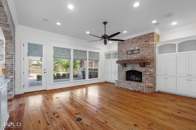 1030 Winterberry Ln, Shreveport, LA 71106 - unfurnished living room with crown molding, a brick fireplace, light wood-type flooring, a ceiling fan, and recessed lighting