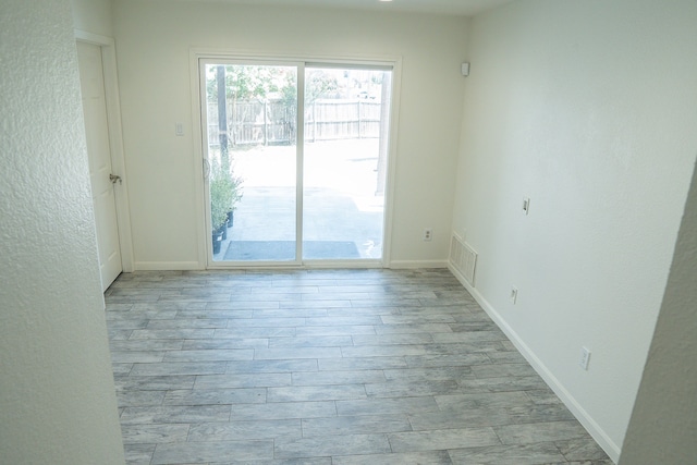 624 Mission Hills Dr, Arlington, TX 76018 - unfurnished room with light wood-style flooring and a textured wall