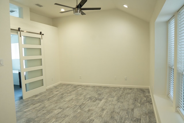 624 Mission Hills Dr, Arlington, TX 76018 - unfurnished bedroom featuring wood finished floors, recessed lighting, a barn door, lofted ceiling, and ceiling fan