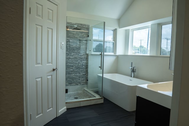 624 Mission Hills Dr, Arlington, TX 76018 - full bathroom with a shower stall, a soaking tub, lofted ceiling, and vanity