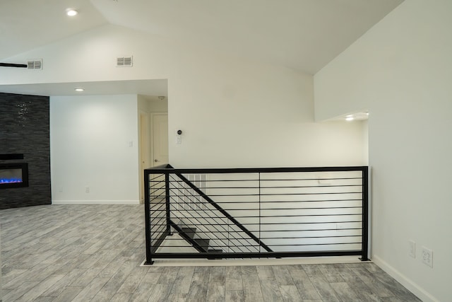 624 Mission Hills Dr, Arlington, TX 76018 - hallway featuring wood finished floors, high vaulted ceiling, and an upstairs landing