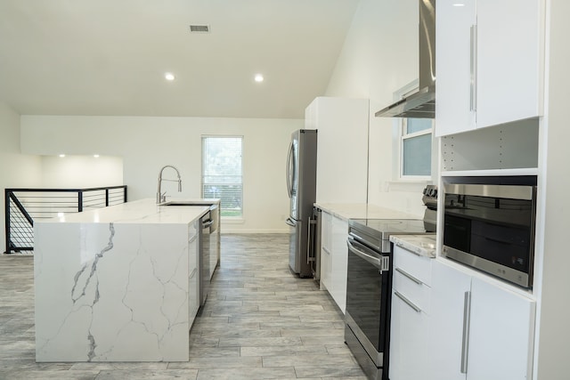 624 Mission Hills Dr, Arlington, TX 76018 - kitchen featuring appliances with stainless steel finishes, modern cabinets, wall chimney range hood, a kitchen island with sink, and white cabinets