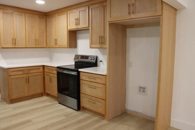 129 Oak Trl, Burleson, TX 76028 - kitchen featuring stainless steel range with electric stovetop, light wood-type flooring, light brown cabinetry, light countertops, and recessed lighting