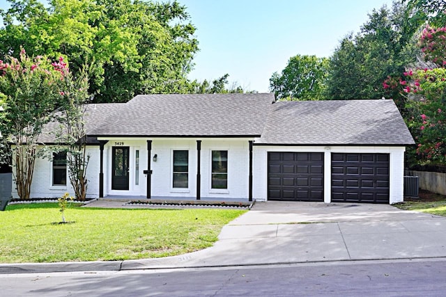 3429 Willowcrest Dr, North Richland Hills, TX 76117 - view of front facade featuring an attached garage, driveway, a front lawn, brick siding, and a shingled roof