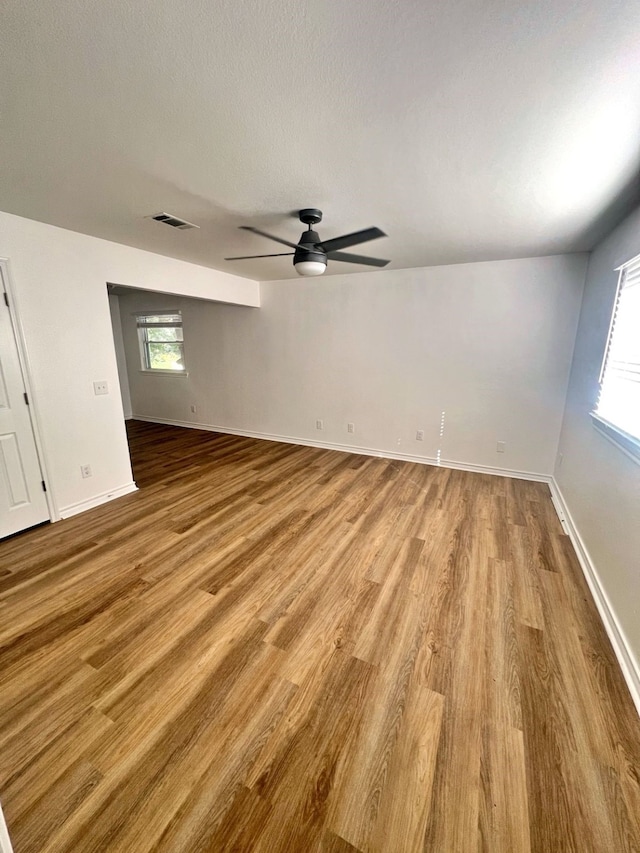 3429 Willowcrest Dr, North Richland Hills, TX 76117 - unfurnished room with a ceiling fan, wood finished floors, and healthy amount of natural light