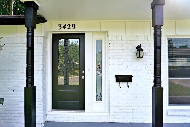 3429 Willowcrest Dr, North Richland Hills, TX 76117 - view of exterior entry featuring brick siding and covered porch