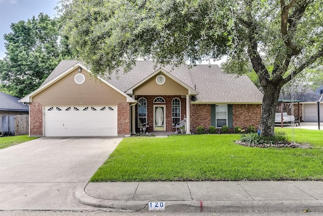 120 Driftwood Ln, Waxahachie, TX 75165 - view of front of home featuring an attached garage, concrete driveway, brick siding, and a front yard