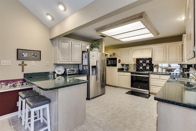 120 Driftwood Ln, Waxahachie, TX 75165 - kitchen featuring stainless steel appliances, a peninsula, a breakfast bar area, tasteful backsplash, and dark stone countertops