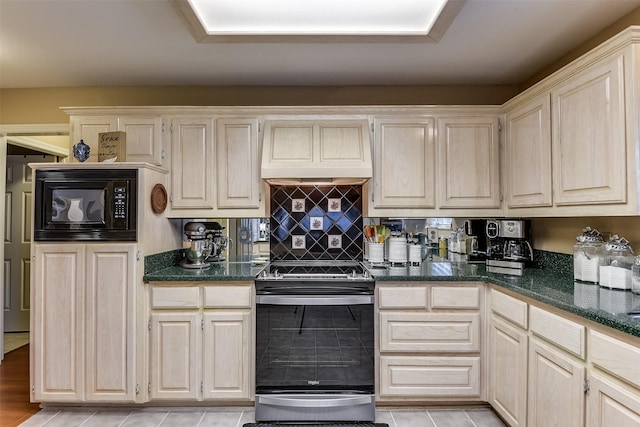 120 Driftwood Ln, Waxahachie, TX 75165 - kitchen with electric stove, premium range hood, black microwave, light tile patterned floors, and backsplash