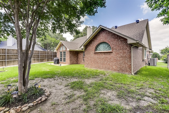 120 Driftwood Ln, Waxahachie, TX 75165 - rear view of property featuring brick siding, a shingled roof, and a chimney