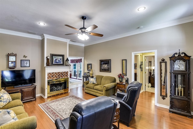 120 Driftwood Ln, Waxahachie, TX 75165 - living area featuring a ceiling fan, wood finished floors, crown molding, a tiled fireplace, and recessed lighting