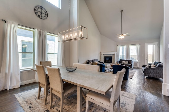 333 Foxthorne Way, Little Elm, TX 75068 - dining room featuring high vaulted ceiling, a fireplace, dark wood-style flooring, and ceiling fan
