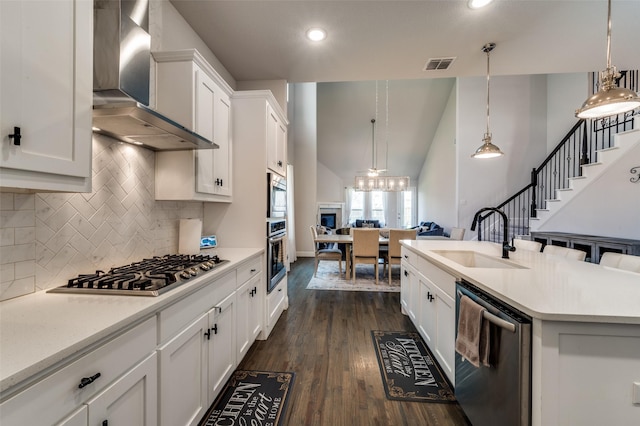 333 Foxthorne Way, Little Elm, TX 75068 - kitchen with appliances with stainless steel finishes, wall chimney exhaust hood, high vaulted ceiling, light countertops, and white cabinets