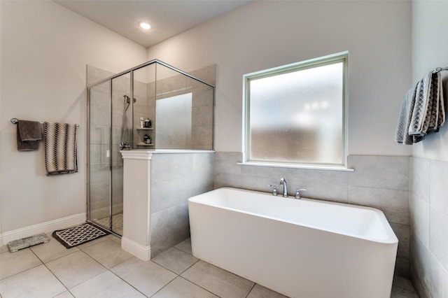 333 Foxthorne Way, Little Elm, TX 75068 - full bath with a freestanding tub, a shower stall, tile patterned flooring, and tile walls
