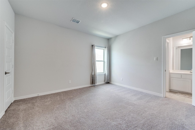 333 Foxthorne Way, Little Elm, TX 75068 - unfurnished bedroom with light colored carpet and connected bathroom