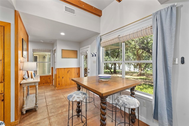 3125 County Road 264, Breckenridge, TX 76424 - dining room with a wainscoted wall, beamed ceiling, wood walls, recessed lighting, and light tile patterned flooring