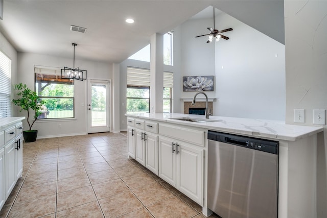 2469 Sleepy Hollow Trl, Frisco, TX 75033 - kitchen with dishwasher, light tile patterned flooring, white cabinetry, a ceiling fan, and light stone countertops