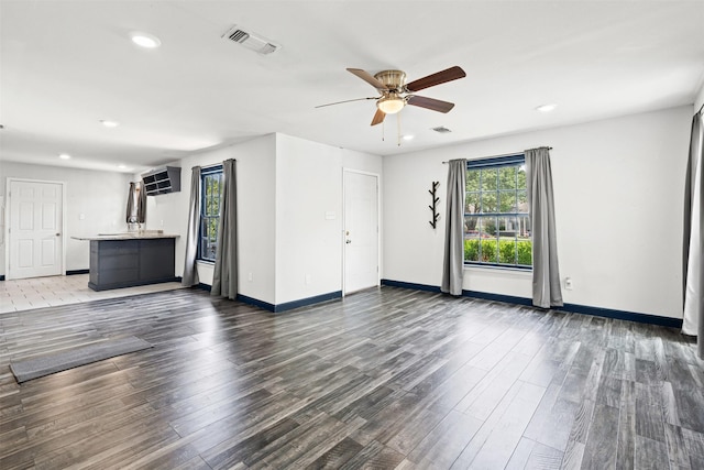 1212 E Mulkey St, Fort Worth, TX 76104 - unfurnished living room with wood finished floors, a ceiling fan, and recessed lighting