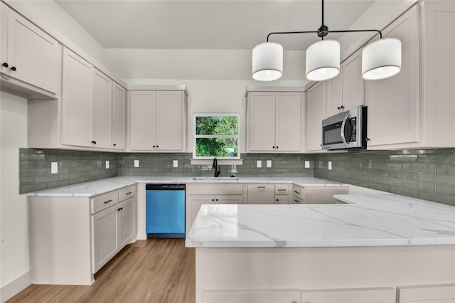1604 Franklin St, Weatherford, TX 76086 - kitchen with dishwasher, stainless steel microwave, light stone countertops, and a peninsula