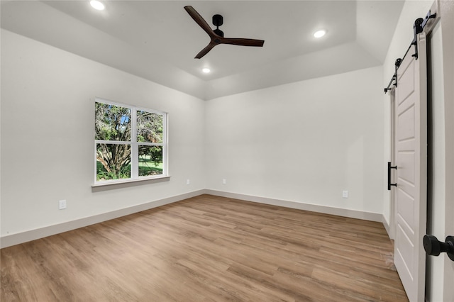 1604 Franklin St, Weatherford, TX 76086 - spare room featuring a barn door, light wood-style floors, a ceiling fan, and recessed lighting