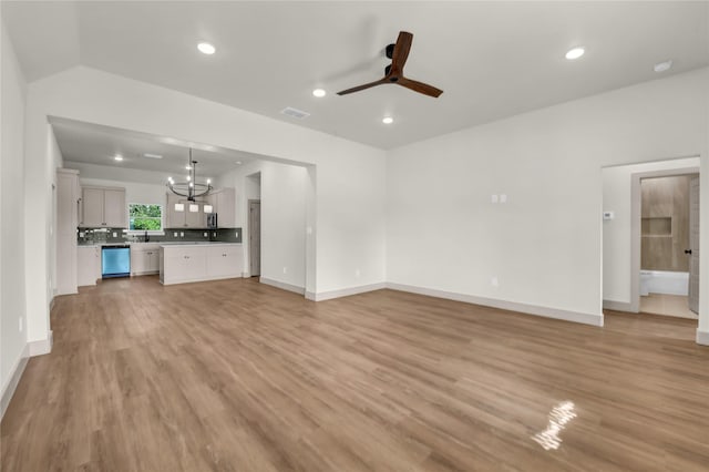 1604 Franklin St, Weatherford, TX 76086 - unfurnished living room featuring a ceiling fan, a chandelier, light wood finished floors, and recessed lighting