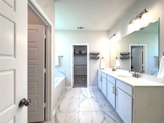 7204 Silent Mill Rd, Arlington, TX 76001 - full bathroom featuring marble finish flooring, double vanity, a garden tub, and a spacious closet