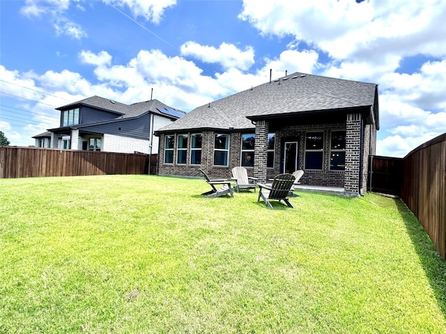 7204 Silent Mill Rd, Arlington, TX 76001 - rear view of house with brick siding, a fenced backyard, and a shingled roof